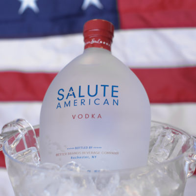 salute bottle in front of flag